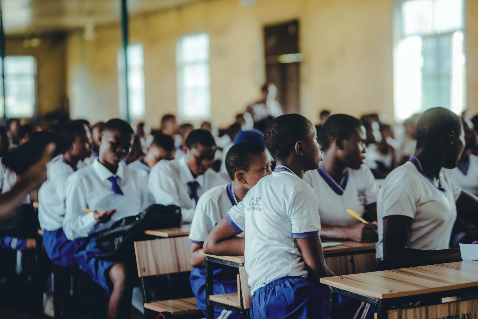 Ghanaian schoolchildren in uniform seated at desks in a classroom