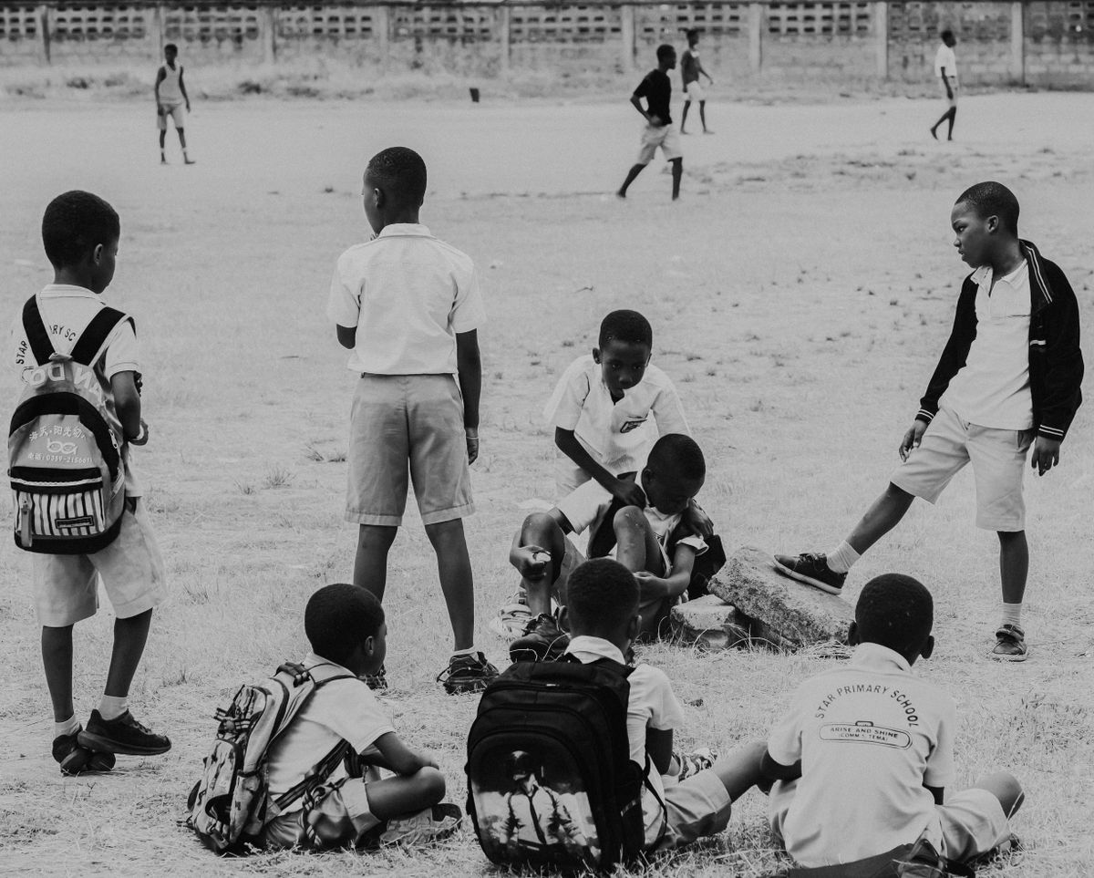 Boys playing soccer in a school yard